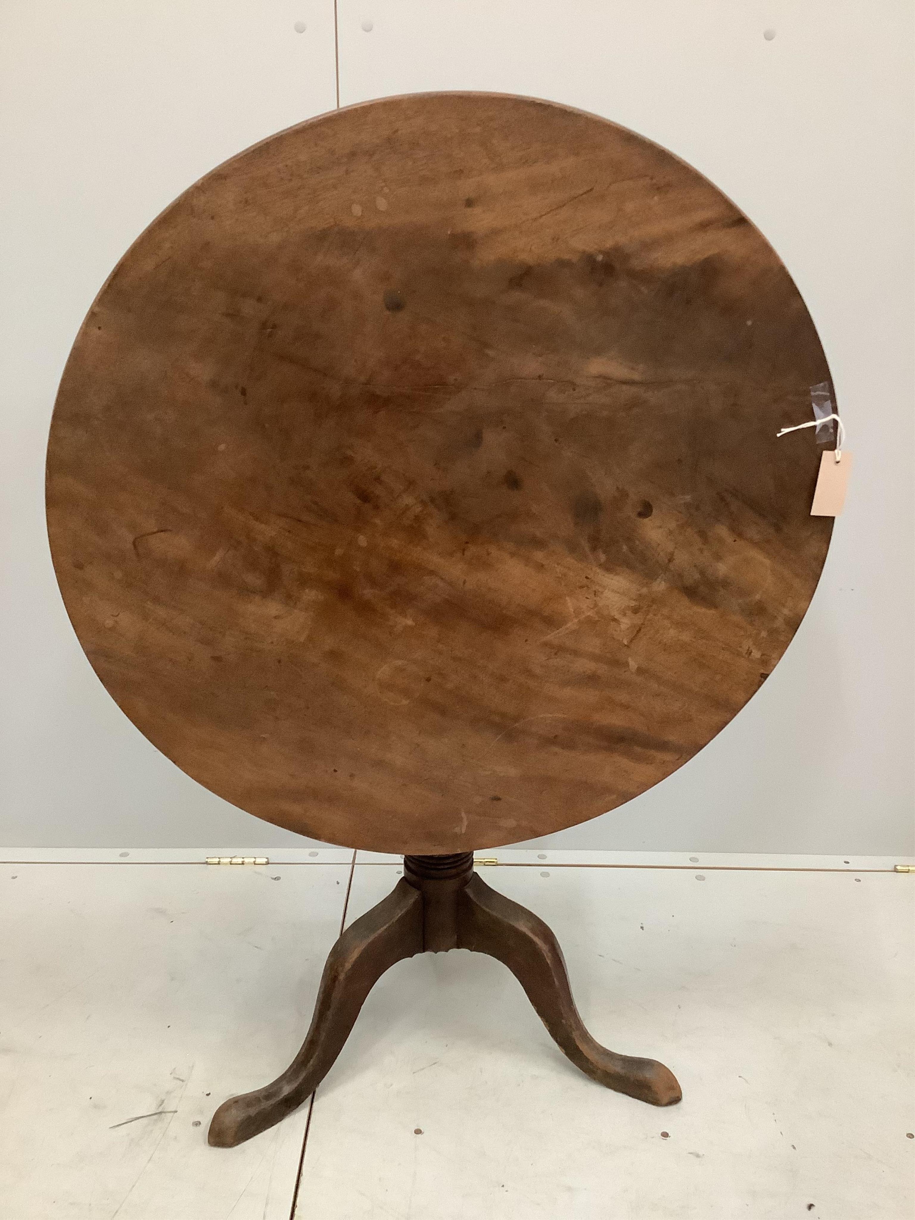 An early 19th century circular mahogany tilt top tripod tea table, diameter 84cm, height 72cm